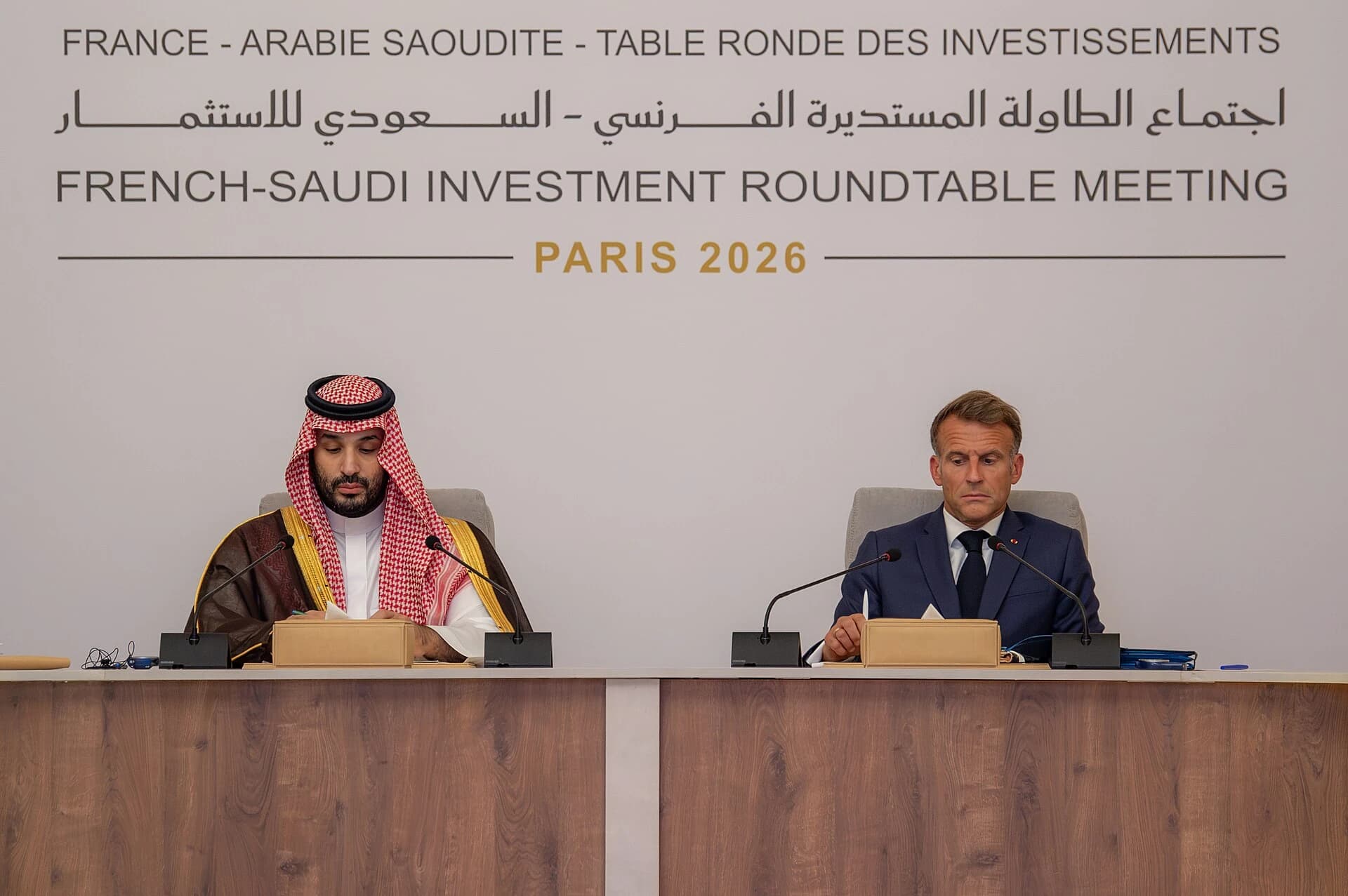 Mohammed bin Salman and French President Emmanuel Macron at the French–Saudi Investment Roundtable in Paris. The image includes the event title banner.