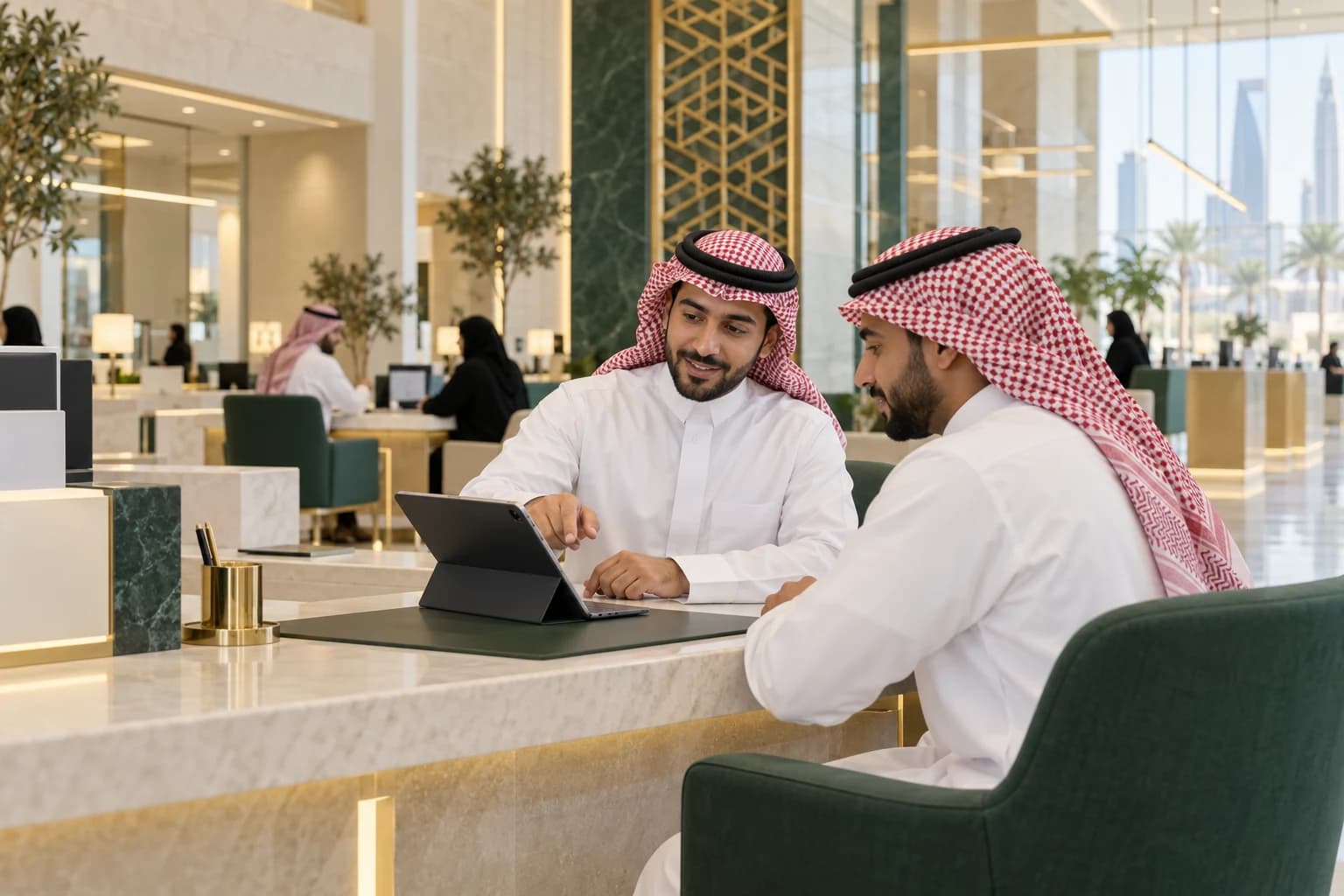 A Saudi business advisor helps an entrepreneur at a contemporary public-service centre.