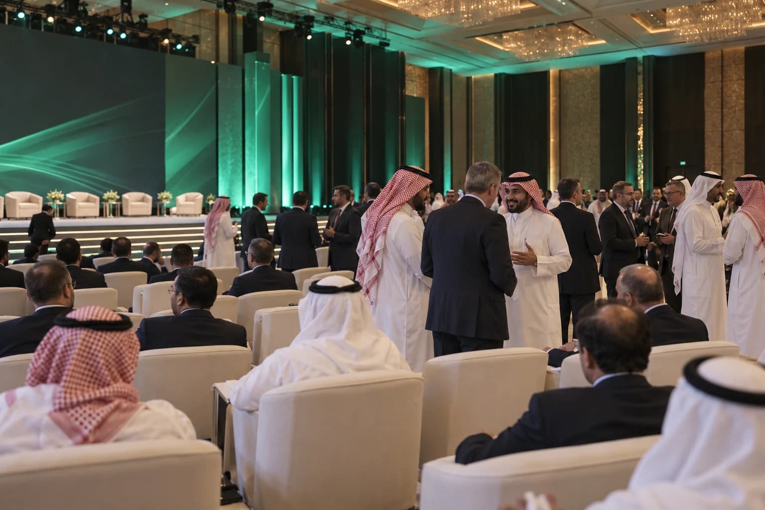 Saudi and international delegates network at a large business federation conference.