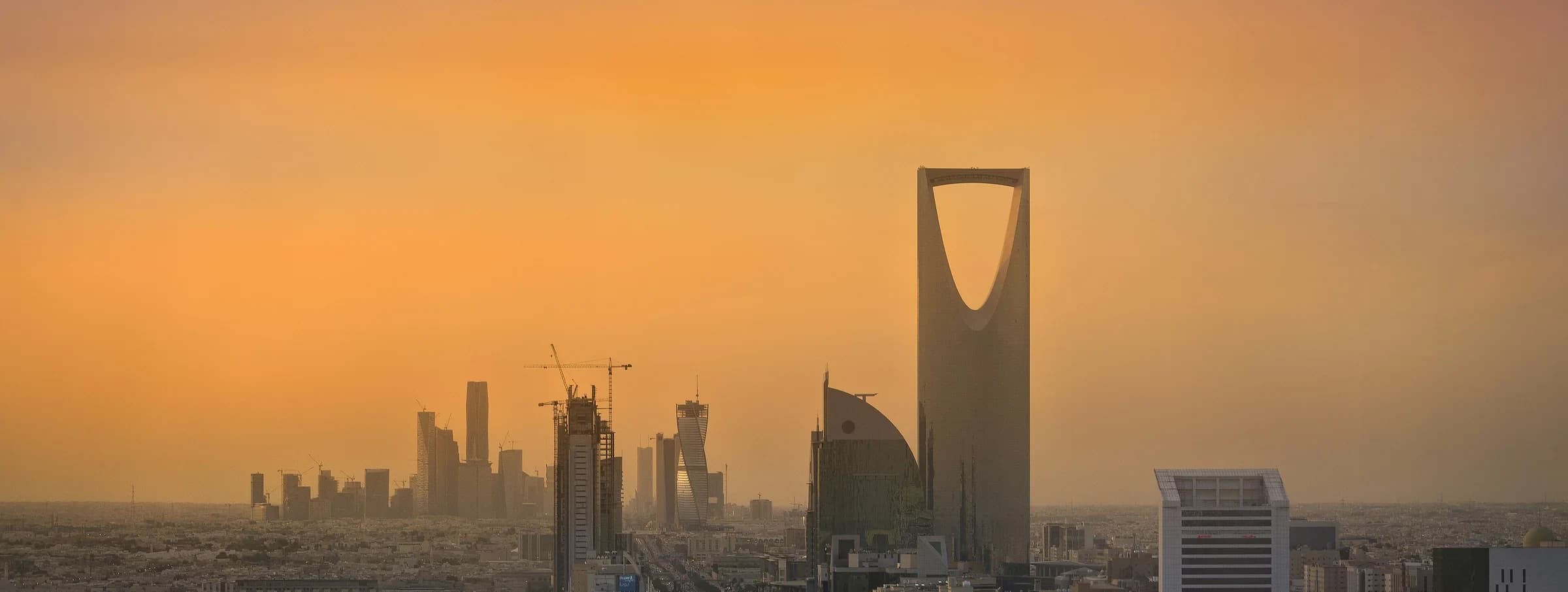 Riyadh skyline with Kingdom Centre at sunset.