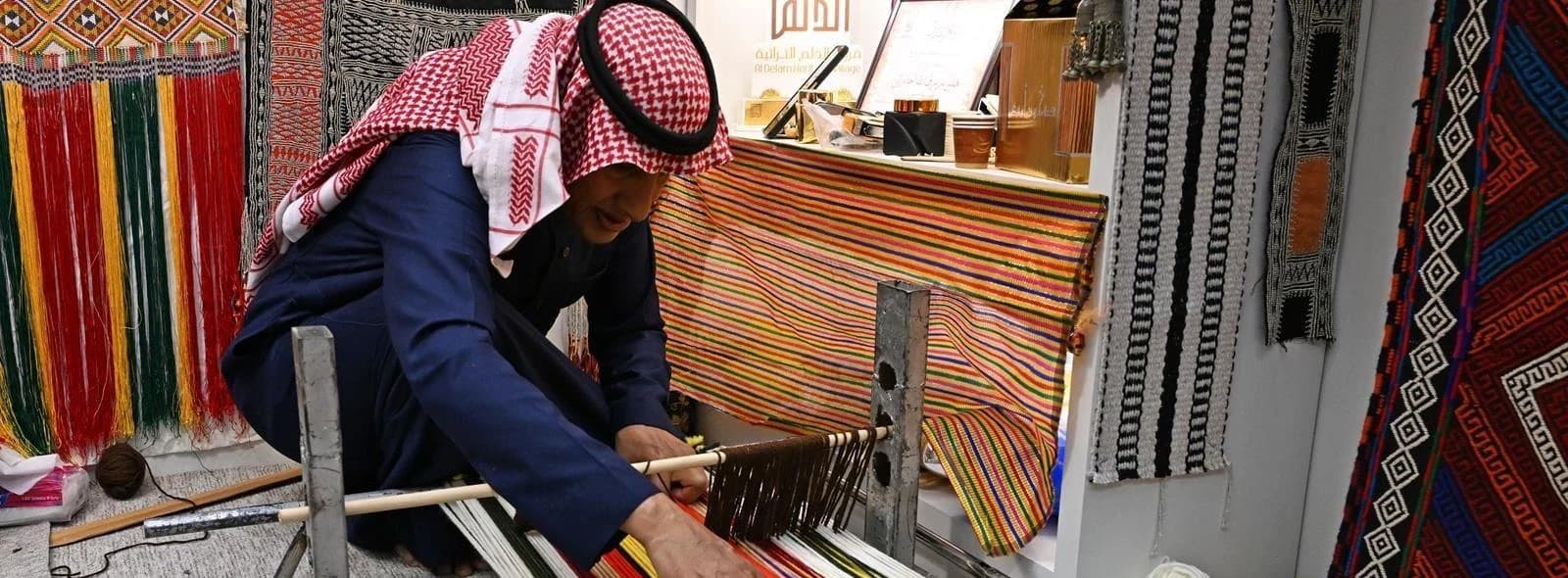 Saudi artisan demonstrating traditional textile weaving
